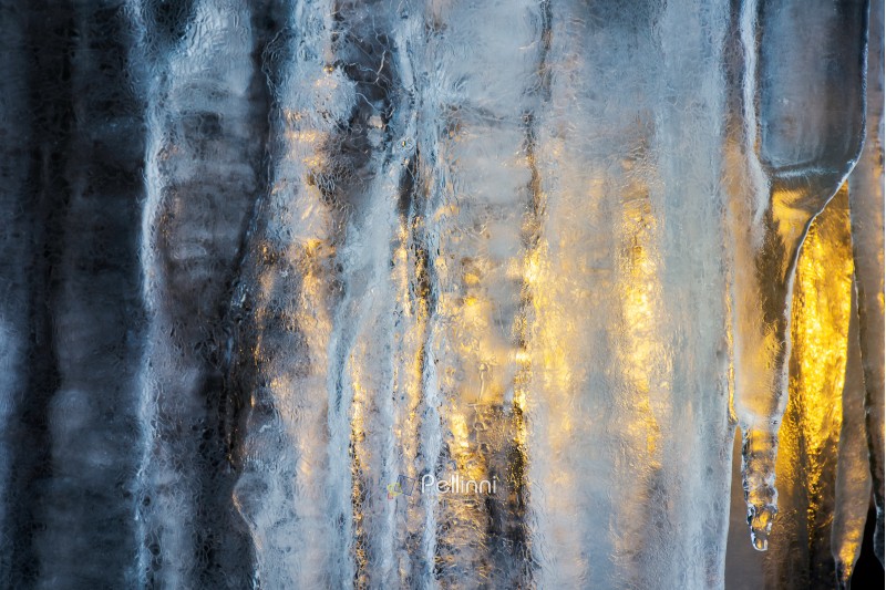 beautiful ice texture lit from behind. ice and sun, cold and warm, winter and spring resistance concept