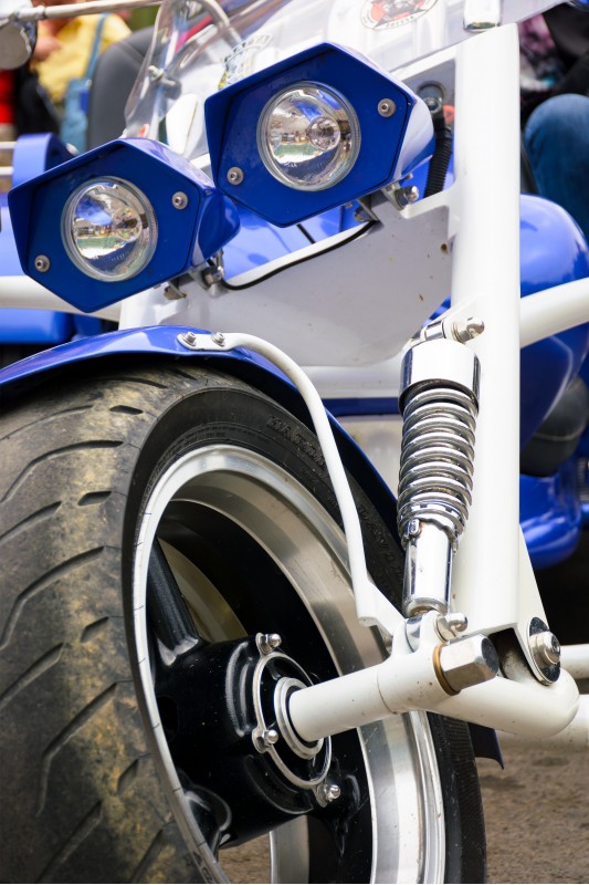 close up details of blue trike with chrome parts
