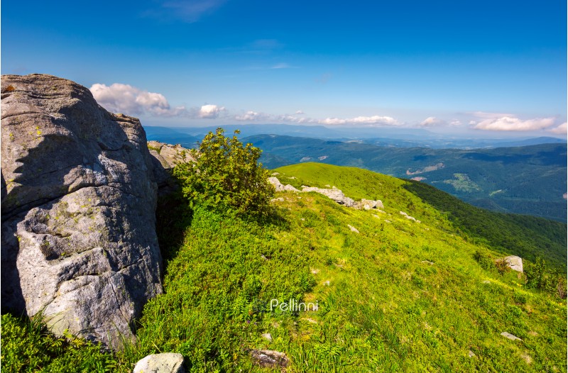 boulders on grassy hills. beautiful mountainous landscape. distant mountain under the cloudy sky. view in to the valley from the top of Runa mountain