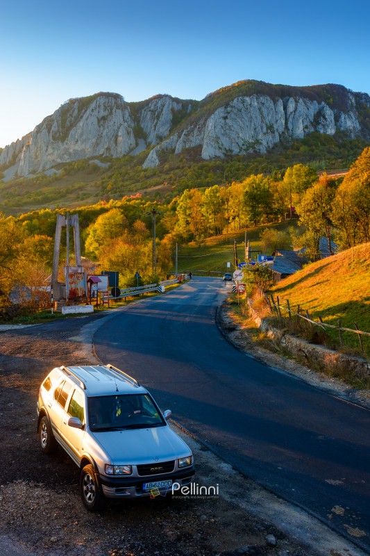 buces-vulcan, romania - 12 oct 2019: suv on the mountain road at sunset in autumn. beautiful alpine scenery of apuseni natural park. traveling through european countryside by car