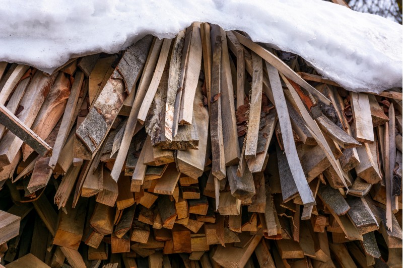 snow covered chopped firewood background