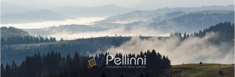panorama of cold morning fog in hot sunrise in the mountains in the morning