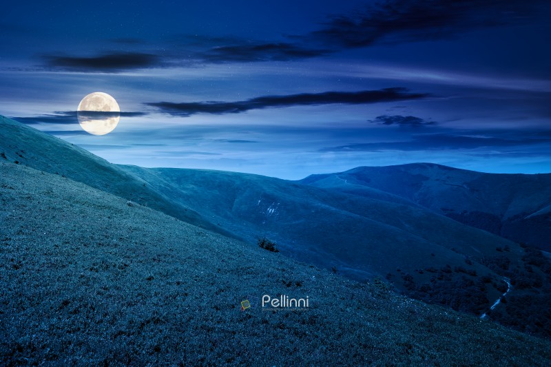discover the beauty of mountain landscape in summer at night. beautiful scenery of ridge with great peak in full moon light