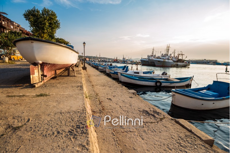 SOZOPOL - AUGUST 16: fishing boats at sunset on August 16, 2015 in Sozopol, Bulgaria. small fishing boats and few big one docked near embankment in port of Bulgarian town Sozopol in evening light