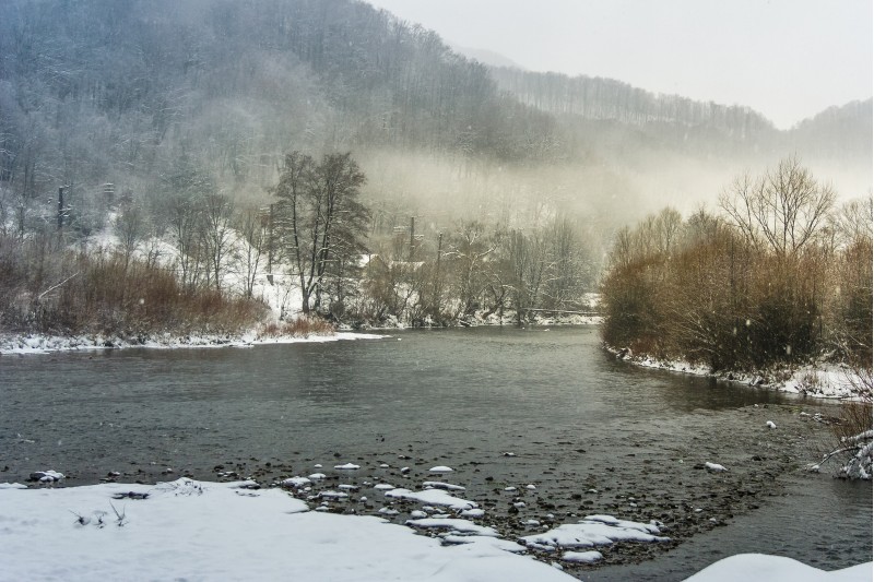 fog on the river in winter countryside. gloomy overcast weather