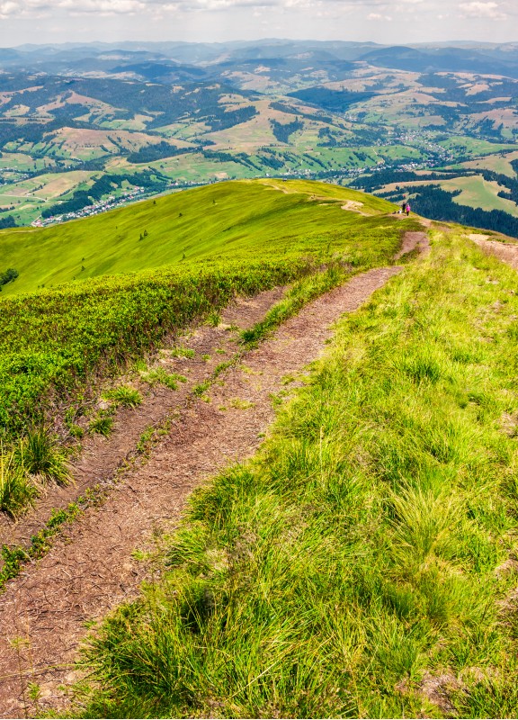 foot path down the grassy hillside. location mountain Gymba, TransCarpathia, Ukraine. tourists climbing hill in the distance. great summer outdoor activities