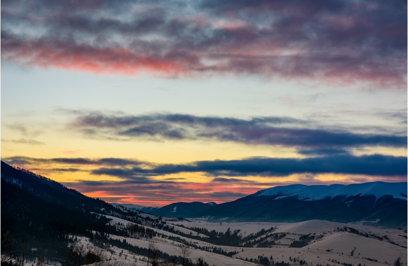 gorgeous colorful clouds over the mountain ridge. beautiful sky at winter dawn