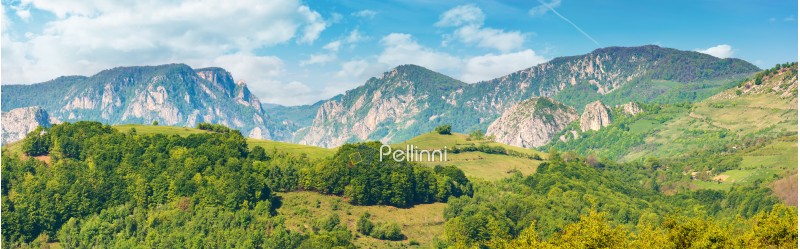 gorgeous panorama of countryside in springtime. beautiful landscape of romania. rural area on the near hills. distant ridge with rocks, cliffs and gorge. wonderful sunny forenoon