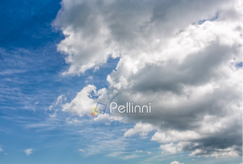heavy grey cloud on a blue summer sky. dramatic weather background with dynamic cloud arrangement