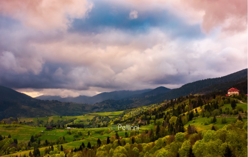 heavy purple clouds over the rural countryside. beautiful landscape of Carpathian mountains in springtime