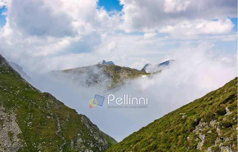 high mountain peak in clouds among the hills. majestic weather in carpathians