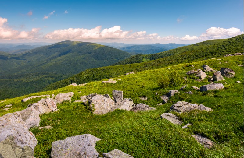 hillside of Runa mountain in summer. beautiful landscape with huge boulders in grass