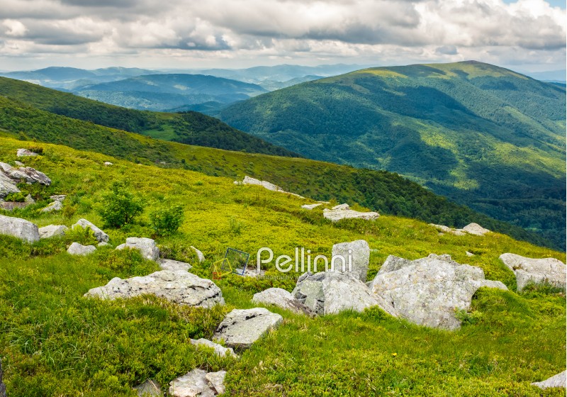 mountain summer landscape. meadow with huge boulders among the grass on top of the hillside near the peak of mountain ridge