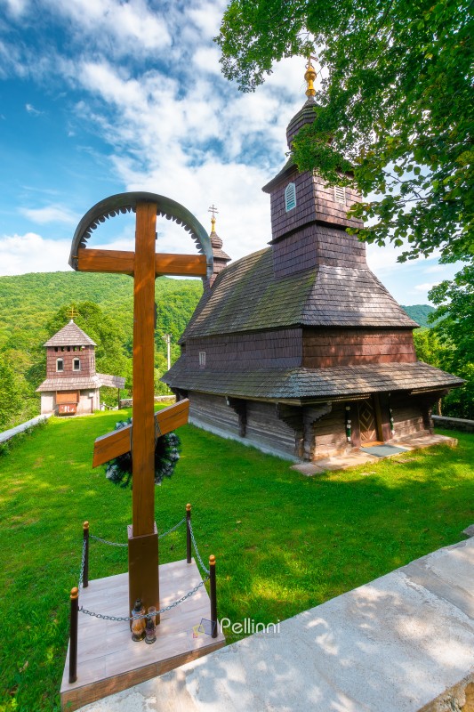 likitsary, transcarpathia, ukraine - 02 jul 2020: traditional wooden church architecture. likitsary, transcarpathia, ukraine - 02 jul 2020: traditional wooden church architecture. picture of an old building made from timber in summer landscape under blue sky. religion heritage of ukraine