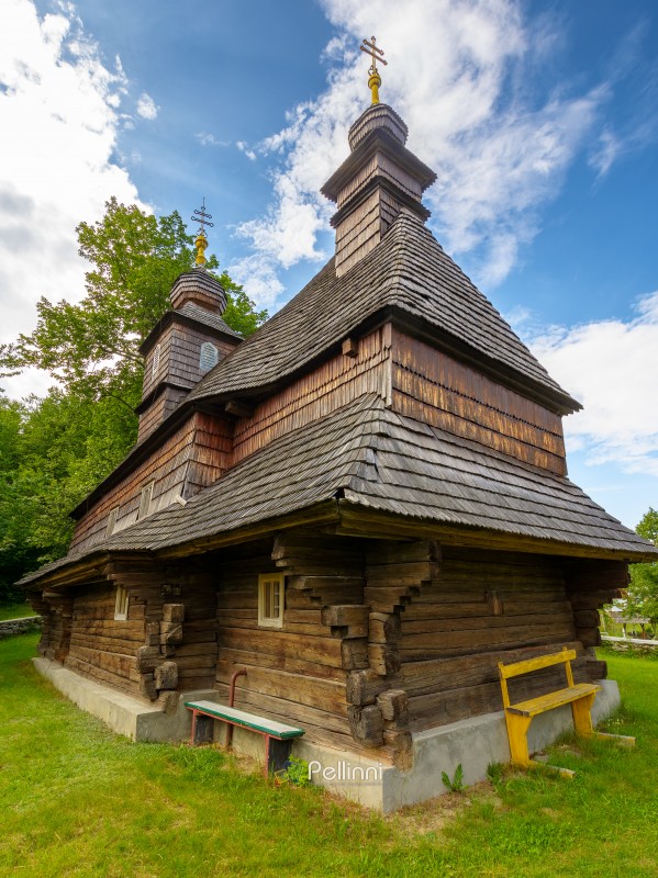 likitsary, transcarpathia, ukraine - 02 jul 2020: traditional wooden church architecture of europe. summer landscape in carpathian mountains. unique ruthenian religion heritage. back view