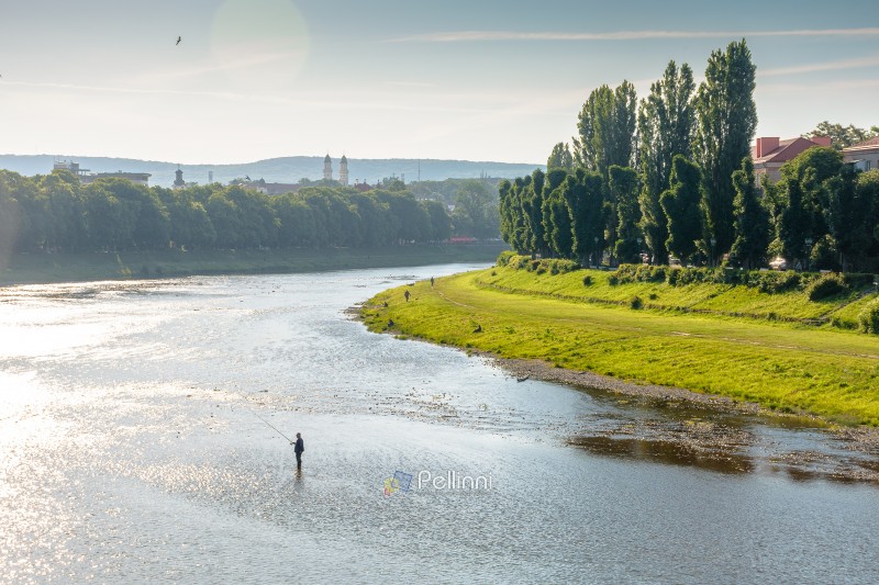 long embankment of the river Uzh in morning light. wonderful urban landscape in early summertime. gorgeous Transcarpathia capital observed from Tomas Masaryk bridge. serene eastern europe metropolis