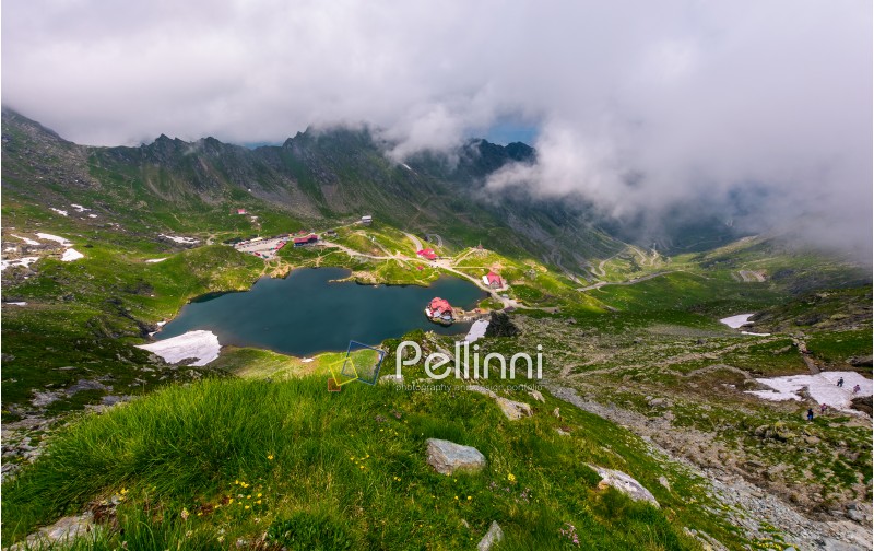 mountain lake Balea view through the clouds. amazing summer landscape of one of the most visited landmarks in Romanian Fagarasan mountains