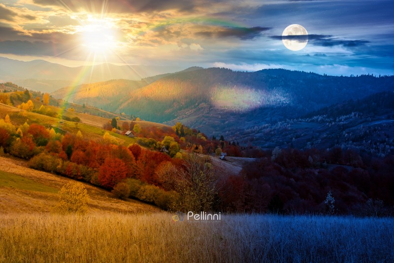 mountain landscape of countryside on autumn equinox. day and nig mountain landscape of countryside on autumn equinox. day and night time change concept. beautiful view of range with dappled light on forested slopes in colorful foliage with sun and moon at twilight