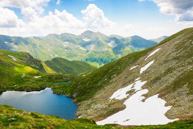 mountain landscape of romania in summer. weather change. beautiful outdoor scenery with alpine lake. scenic view in to the valley. travel background with blue sky and clouds. fagaras ridge 