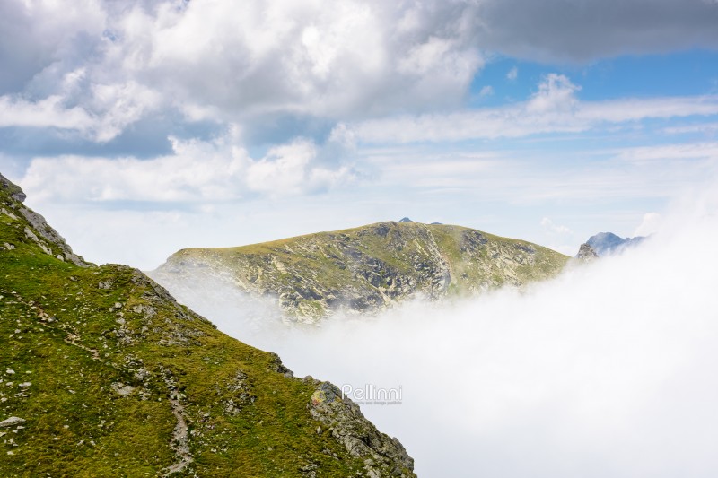 mountain landscape of romania under cloudy sky. europe nature scenery travel background for hiking in summer vacation season. scenic view of fagaras ridge in transylvania alps with steep rocky slopes