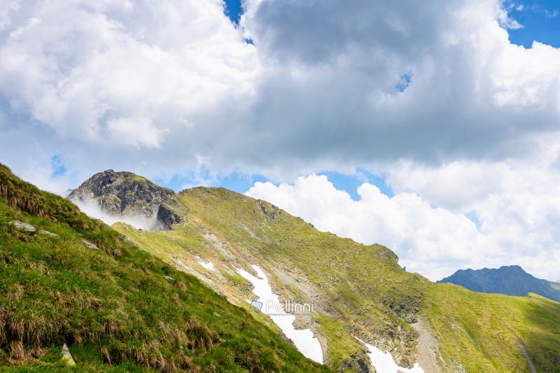 mountain landscape of romania under cloudy sky. europe nature scenery travel background for hiking in summer vacation season. scenic view of fagaras ridge in transylvania alps with steep rocky slopes