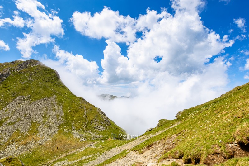 mountain landscape of romania under cloudy sky. europe nature scenery travel background for hiking in summer vacation season. scenic view of fagaras ridge in transylvania alps with steep rocky slopes