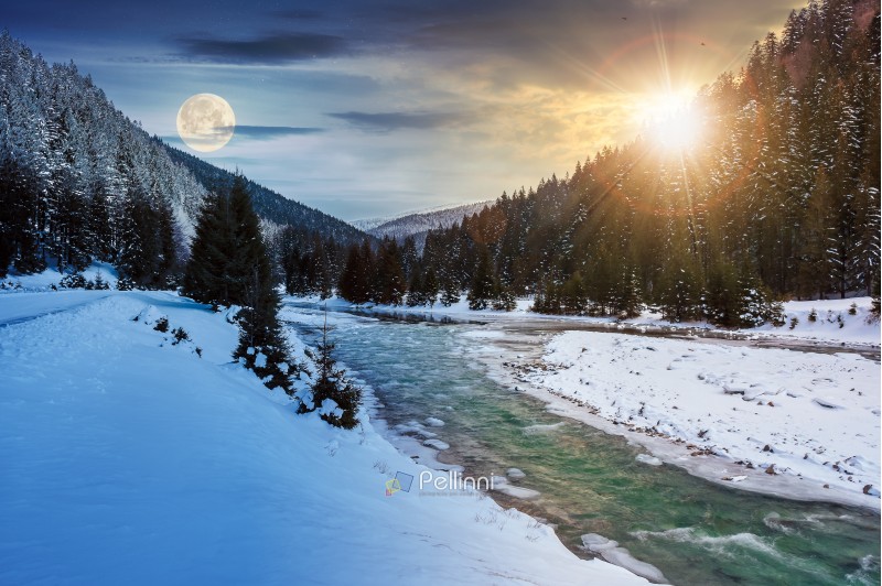 day and night time change concept. mountain river in winter with sun and moon. snow covered river banks. forest in snow on the distant mountain. cloudy morning