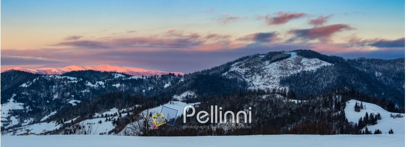 mountainous area of Carpathians in winter on red frosty sunrise