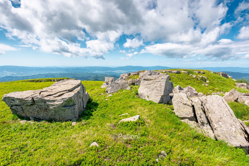 mountainous carpathian landscape during summertime. boulders and rock formations surrounded grassy hills. picture of a sunny forenoon with clouds on the sky. untouched highland of ukraine
