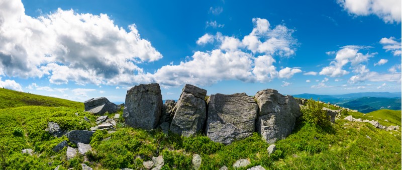 mountainous panorama with boulders on hillside. beautiful summer landscape in fine weather under the lovely cloudscape