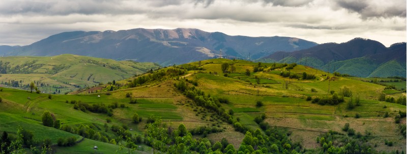 mountainous rural area in springtime. beautiful countryside panorama of rolling hills on a cloudy day