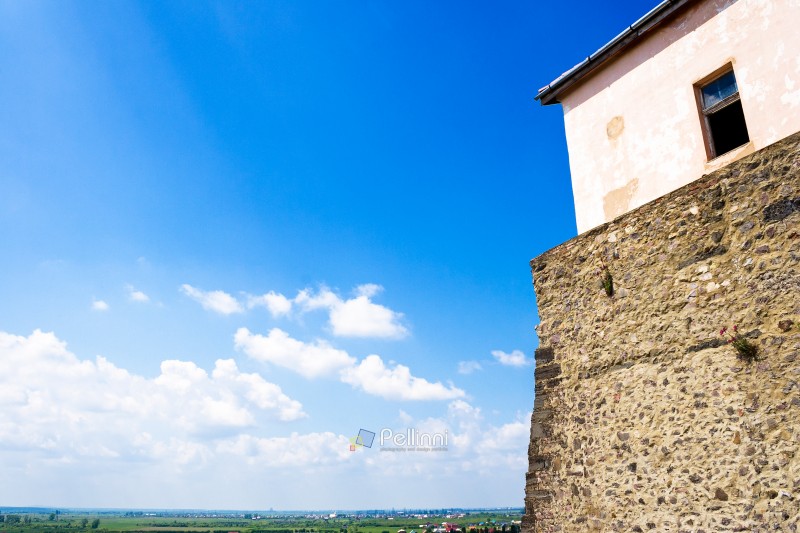 mukachevo, ukraine - may 25, 2008: palanok castle in summertime. old fortification now serves as the museum and is popular tourist landmark of transcarpathia region. urban scenery on a sunny day