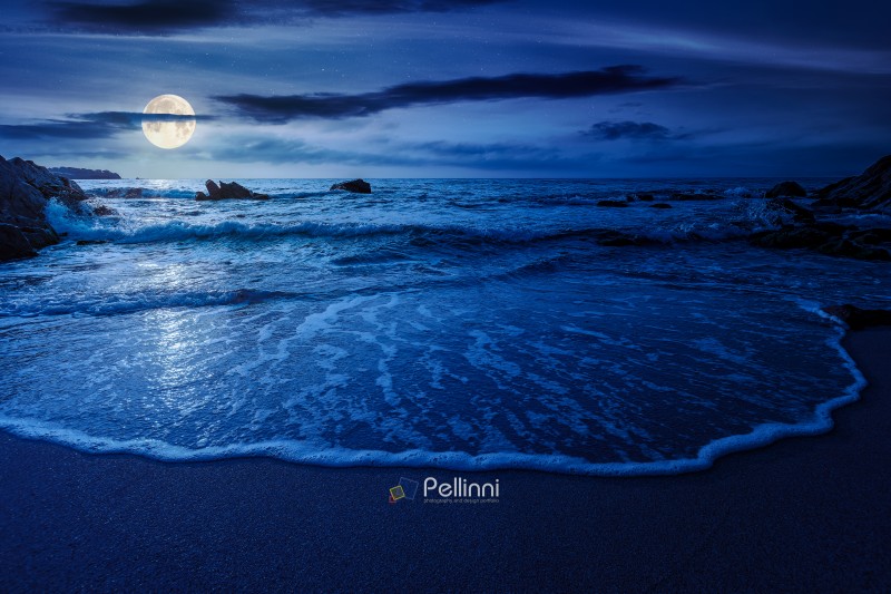 mysterious sandy sea beach at night. full moon over scene on cold summer vacation season. beautiful view of waves washing the sand. generic image of seascape and sky for advertising background