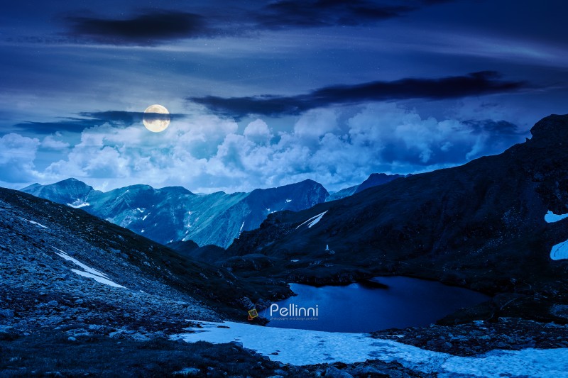 mysterious summer scenery of alpine capra lake with steep slopes mysterious summer scenery of alpine capra lake with steep slopes at night. fantasy view of transylvania alps, sibiu county. full moon over southern carpathian mountains of romania travel background