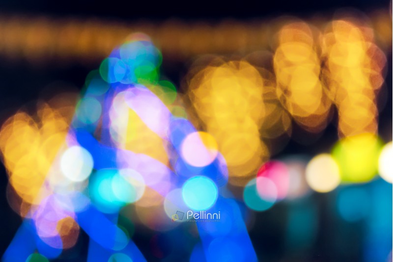 new year tree abstract blur. city light on street in the distance. defocused image