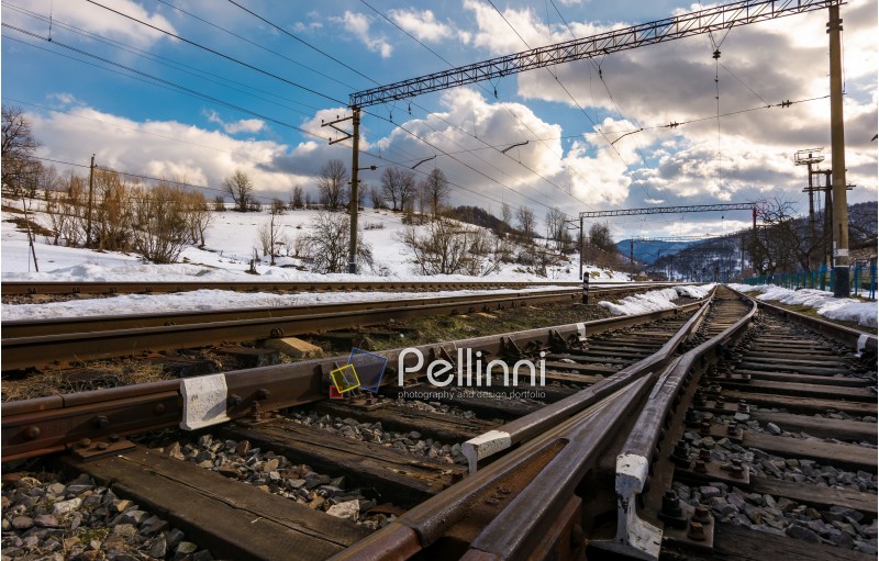 old railroad in winter mountain on a cloudy day. transportation background