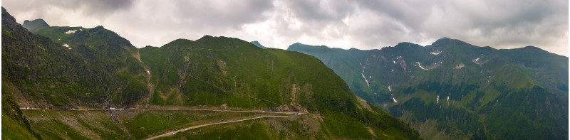 panorama of Fagaras mountains on a cloudy day. beautiful summer landscape with famous Transfagarasan road