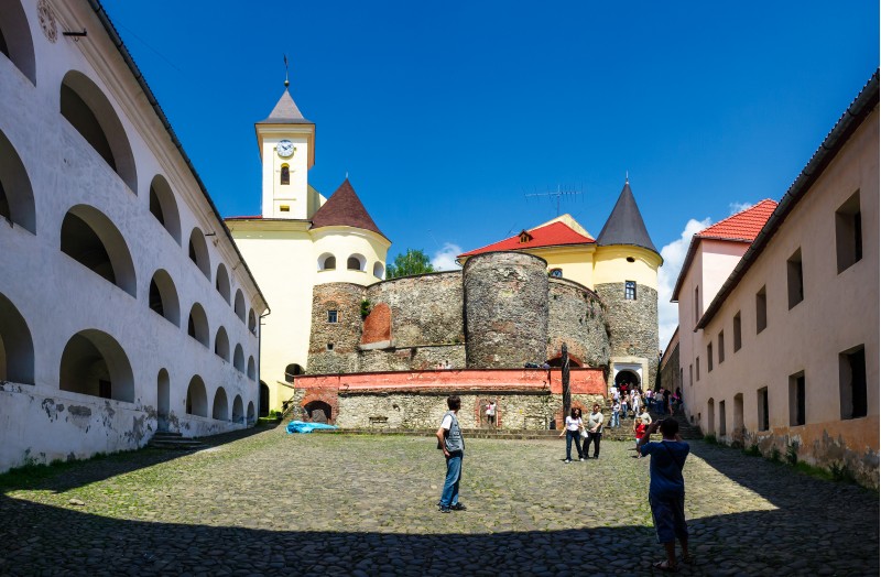 Mukachevo, Ukraine - MAY 25, 2008: panorama of Palanok Castle courtyard with clock tower. Old fortification now serves as the museum and is popular tourist landmark