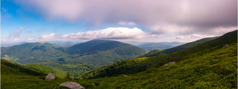 panorama of beautiful mountain landscape. beautiful scenery with clouds coming over the hills