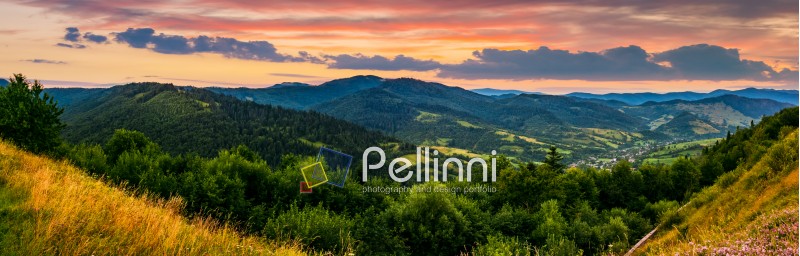 panorama of mountain ridge with peak behind the hillside. beautiful summer background at sunset with red sky
