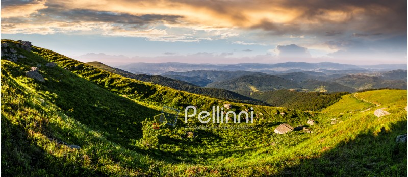 panorama of mountain ridge with peak behind the hillside. beautiful summer background at sunset with cloudy sky