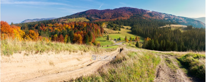 panorama of mountainous landscape in autumn. country road down the hill. parking lot in the valley. forest in fall colors