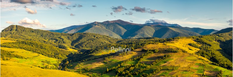 panorama of mountainous rural area in autumn. wonderful countryside with agricultural fields on hills. gorgeous Borzhava ridge in the distance