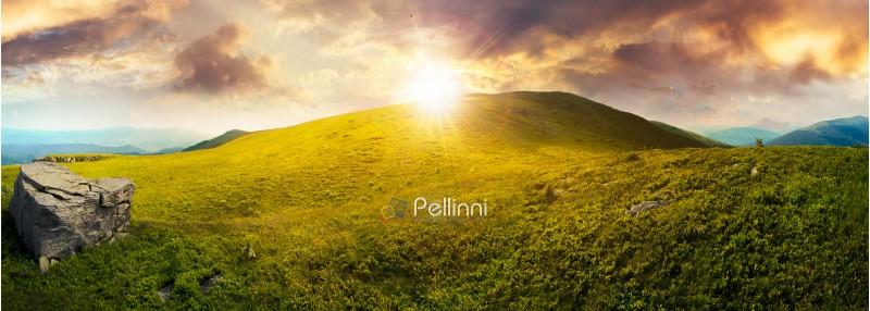 panorama with rock on the grassy hill in mountains. beautiful summer landscape in evening light. amazing nature scenery. dramatic cloudy sky at sunset