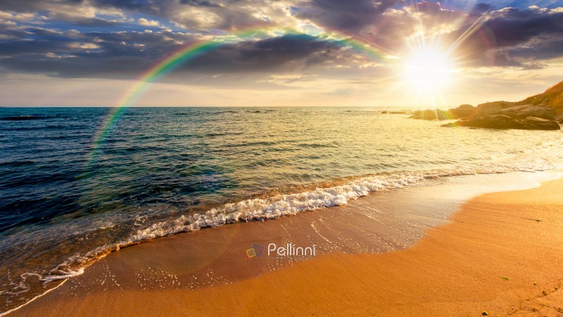 panoramic view of sand beach landscape at sunset. summer vacatio panoramic view of sand beach landscape at sunset. summer vacation season at the sea in evening light. beautiful seaside of with calm water under rainbow. wide coast travel banner