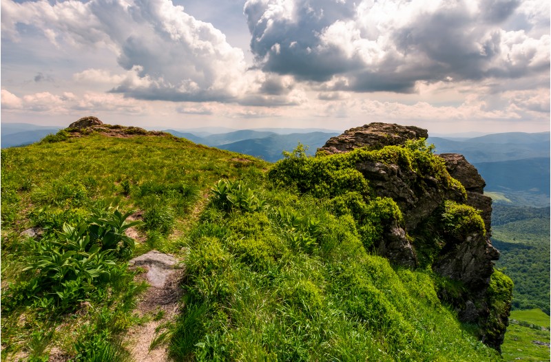 path to the edge of a rocky cliff. beautiful landscape of Carpathian mountains on a cloudy summer day