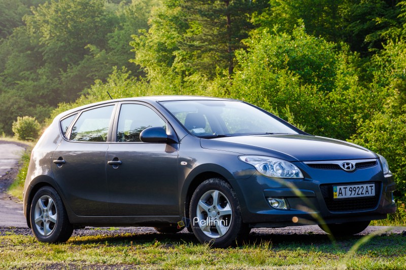 perechyn, ukraine - jun 10 2020: car near winding country road on summer sunrise. beautiful view of mountain in the background. automotive photography in carpathians. countryside scenery wallpaper