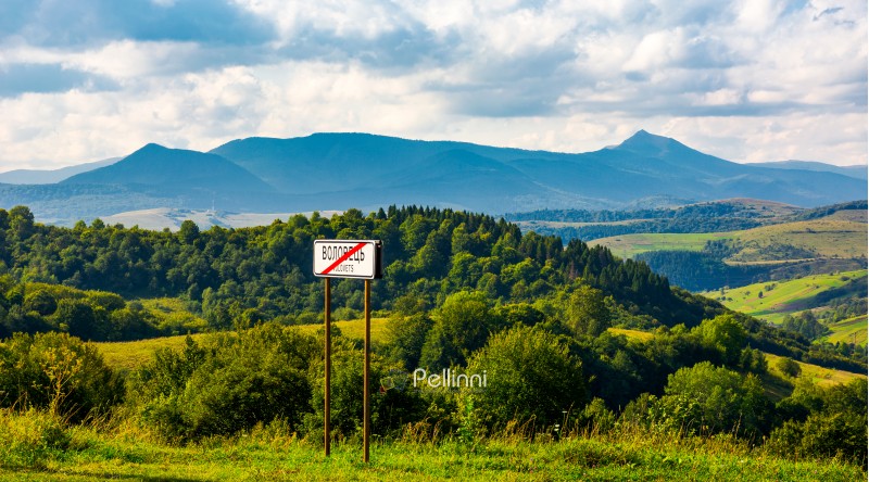 road sign on the hillside. mountain ridge  with Pikui peak in the distance. Carpathian travel destination concept. location Volovets, TransCarpathia, Ukraine