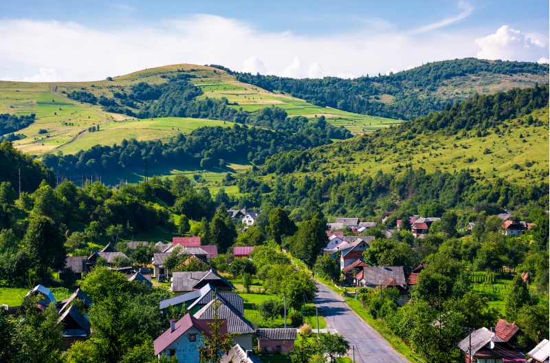 road through village in Carpathian mountains. bird eye view of beautiful rural scenery in summertime