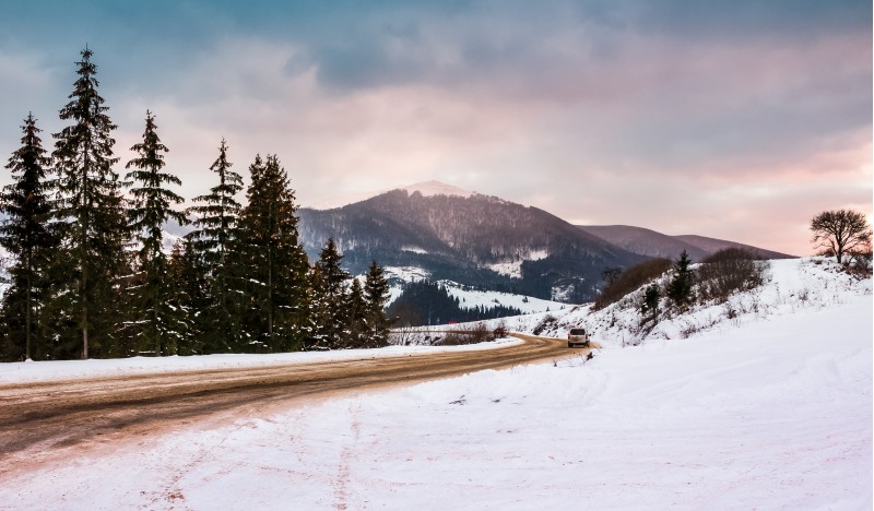 road turnaround near the forest in snowy mountains. lovely transportation winter scenery in Carpathian mountains